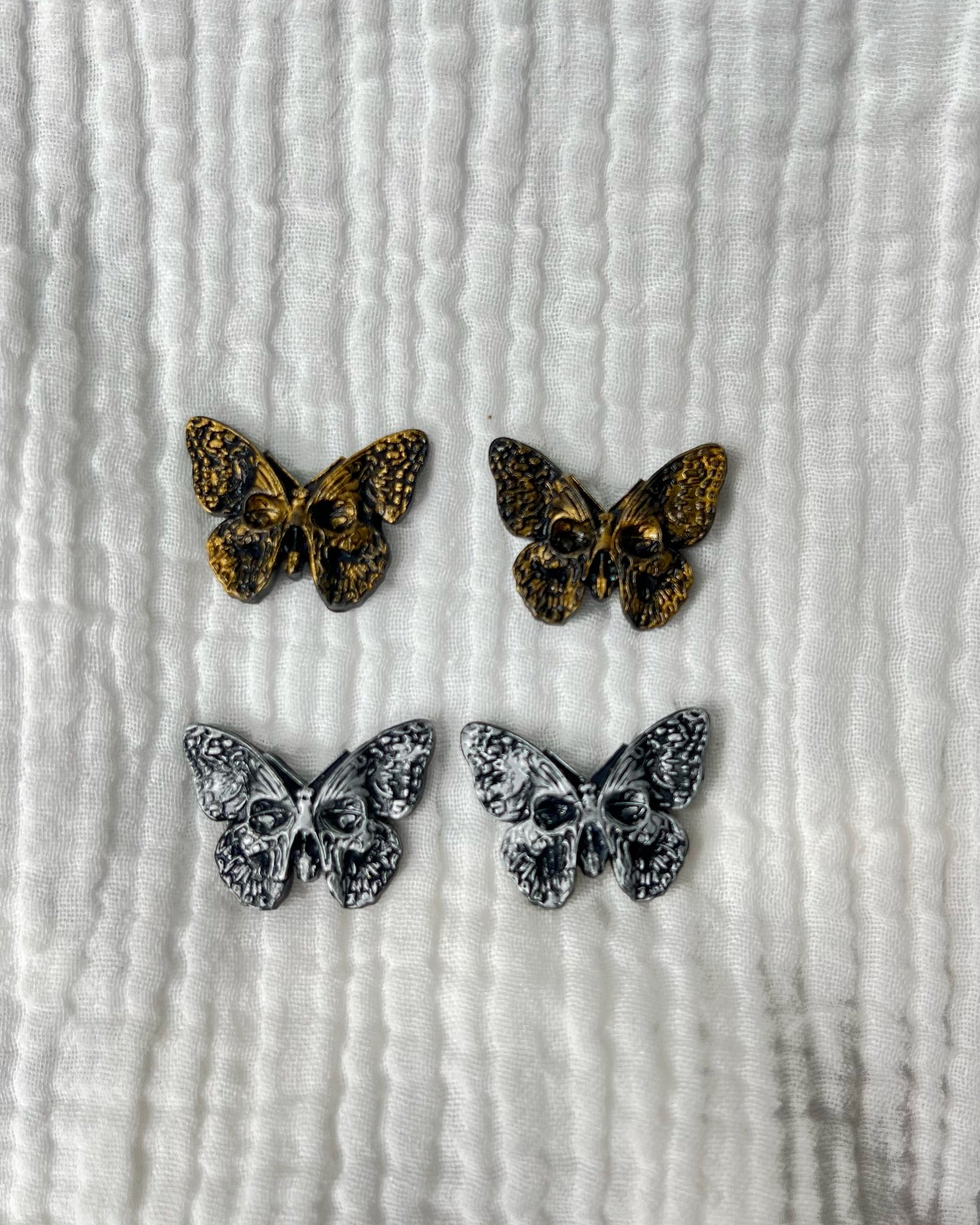 Skull butterfly stud
